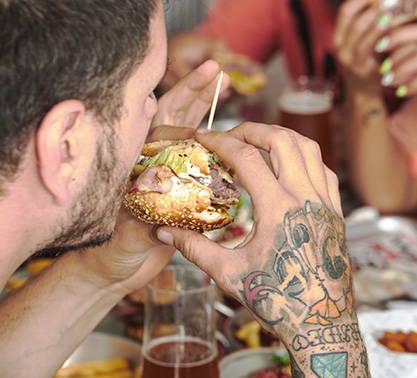 A person eating a burger with both hands.
